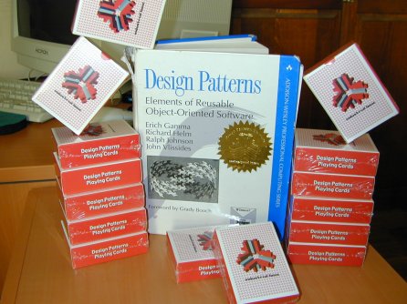 boxes of Design Pattern playing cards leaning against the Design Patterns book