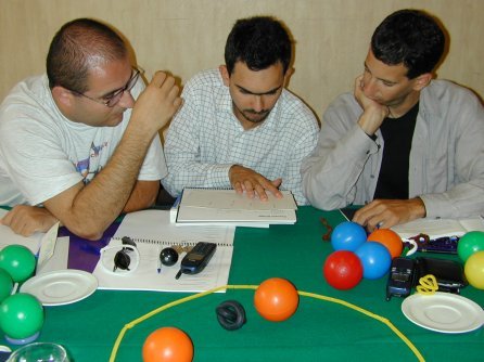 Three people looking at cards on a table