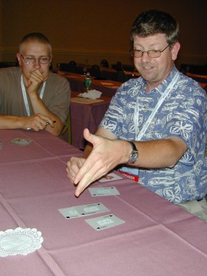 a person pointing to their hand while another person watches