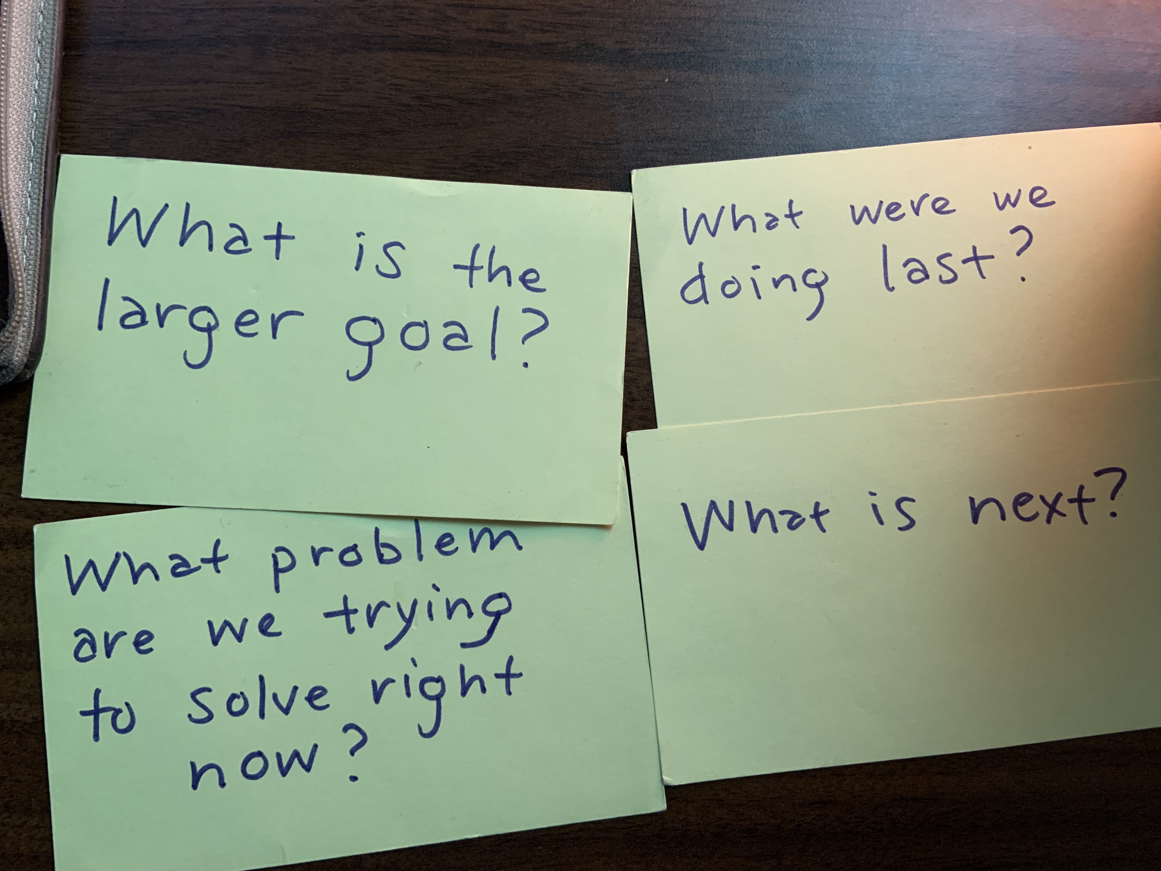 Four stickies with a hand-written question on each.